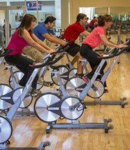 Four adults in an indoor cycling call